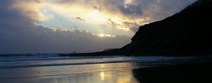 A watery sunset on Porth Luney Beach.